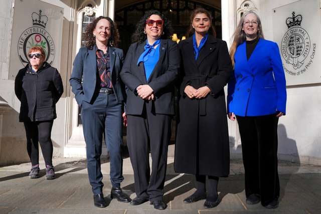 People await a ruling on an appeal by For Women Scotland outside the Supreme Court in London