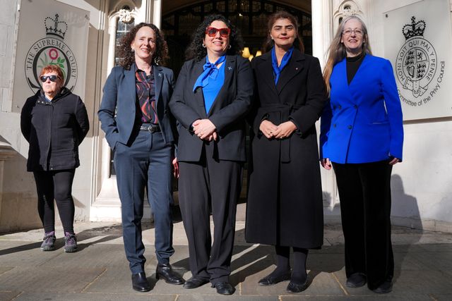 People await a ruling on an appeal by For Women Scotland outside the Supreme Court in London