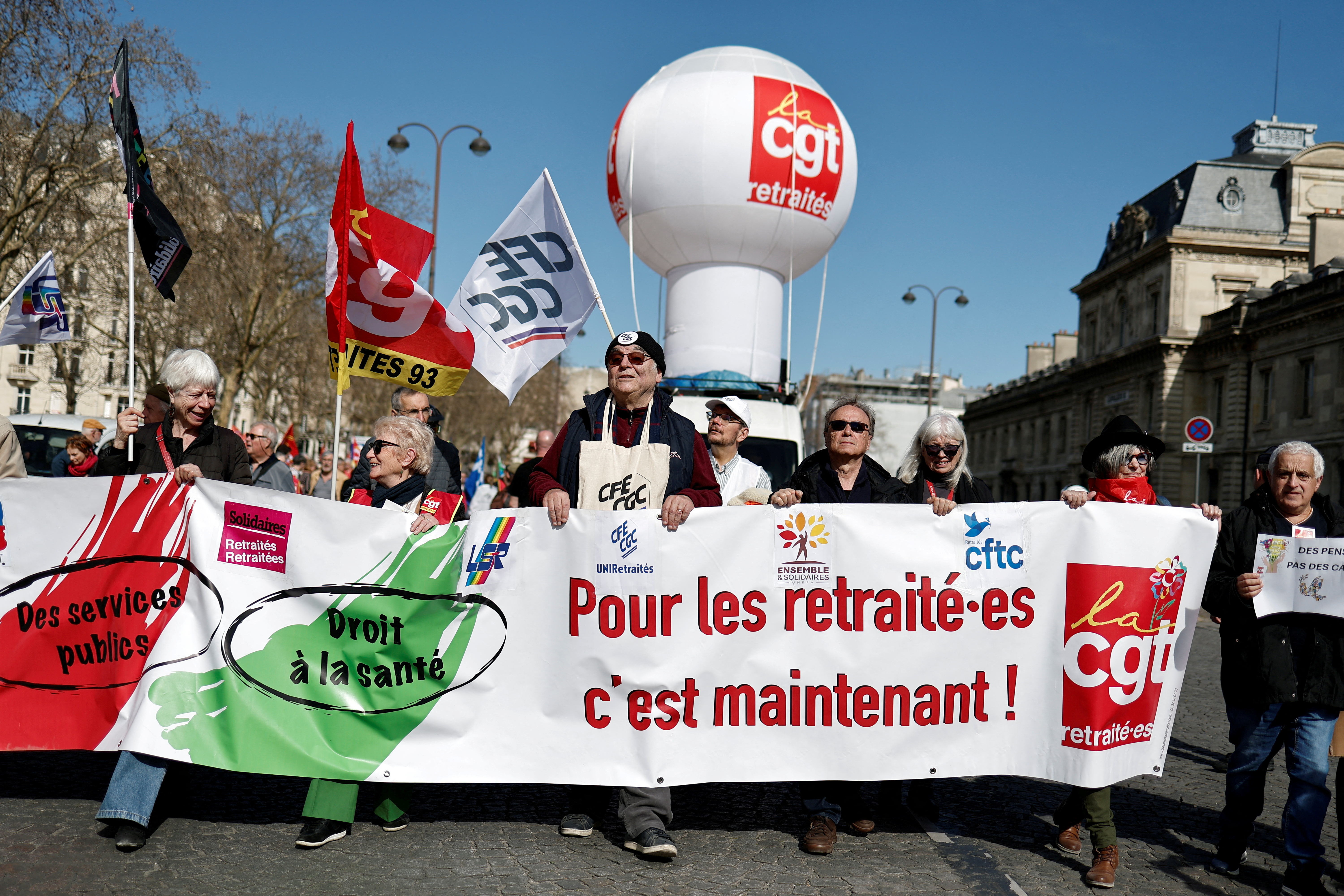 FILE PHOTO: People protest for security and an increase in pensions in Paris