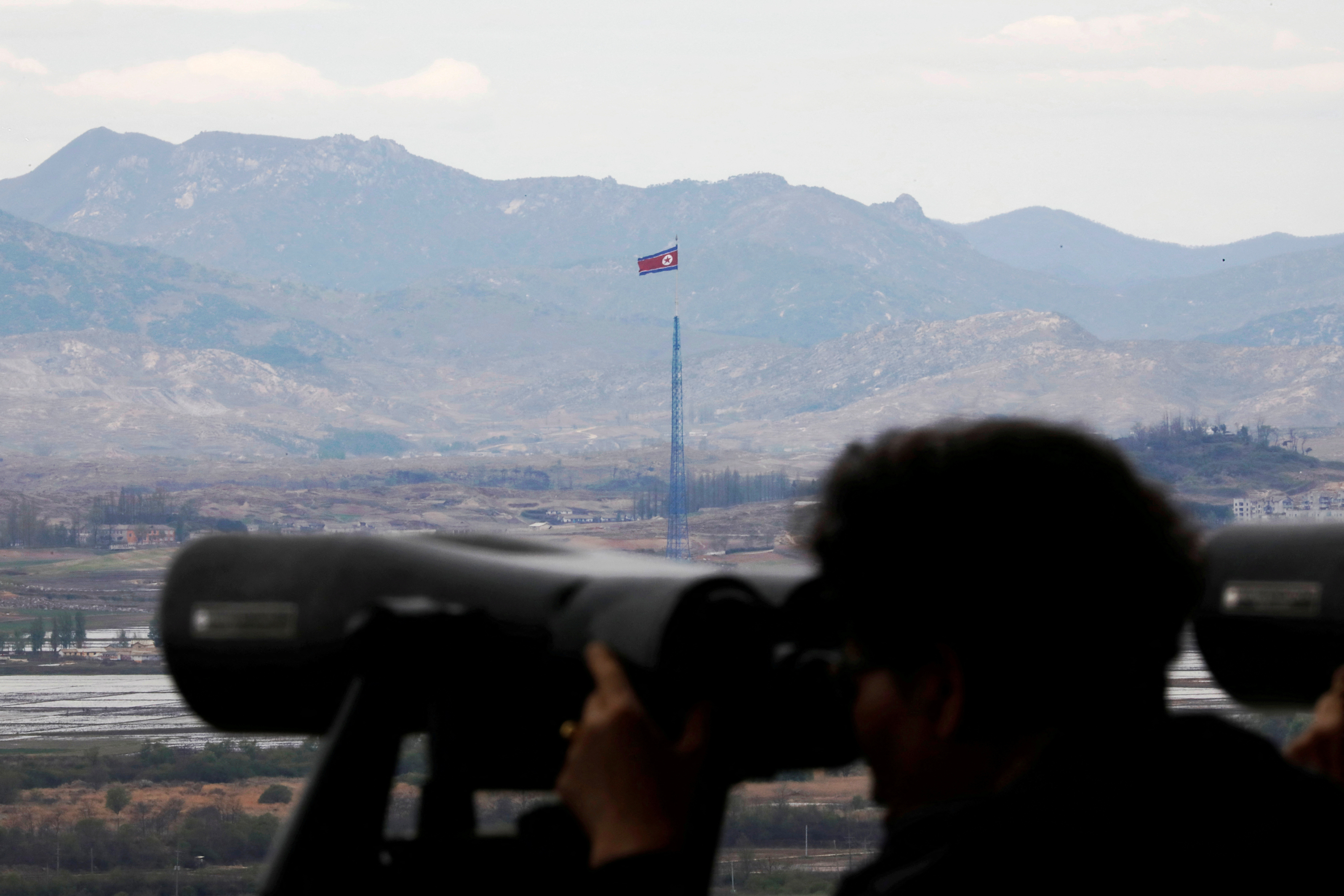 FILE PHOTO: A North Korean flag flutters on top of a 160-metre tower in North Korea's propaganda village of Gijungdong in this picture taken from the Dora observatory near the demilitarised zone separating the two Koreas, in Paju