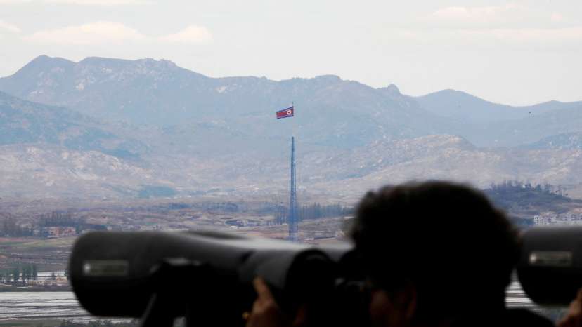 FILE PHOTO: A North Korean flag flutters on top of a 160-metre tower in North Korea's propaganda village of Gijungdong in this picture taken from the Dora observatory near the demilitarised zone separating the two Koreas, in Paju