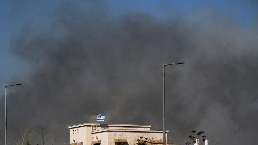 Smoke billows behind a house following over border attacks from Lebanon, in Katzrin in the Israeli-occupied Golan Heights