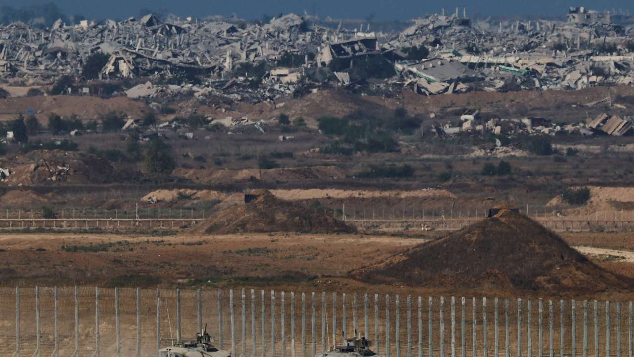 Israeli armoured personnel carriers (APC) manoeuvre on Israeli side of the Israel-Gaza border