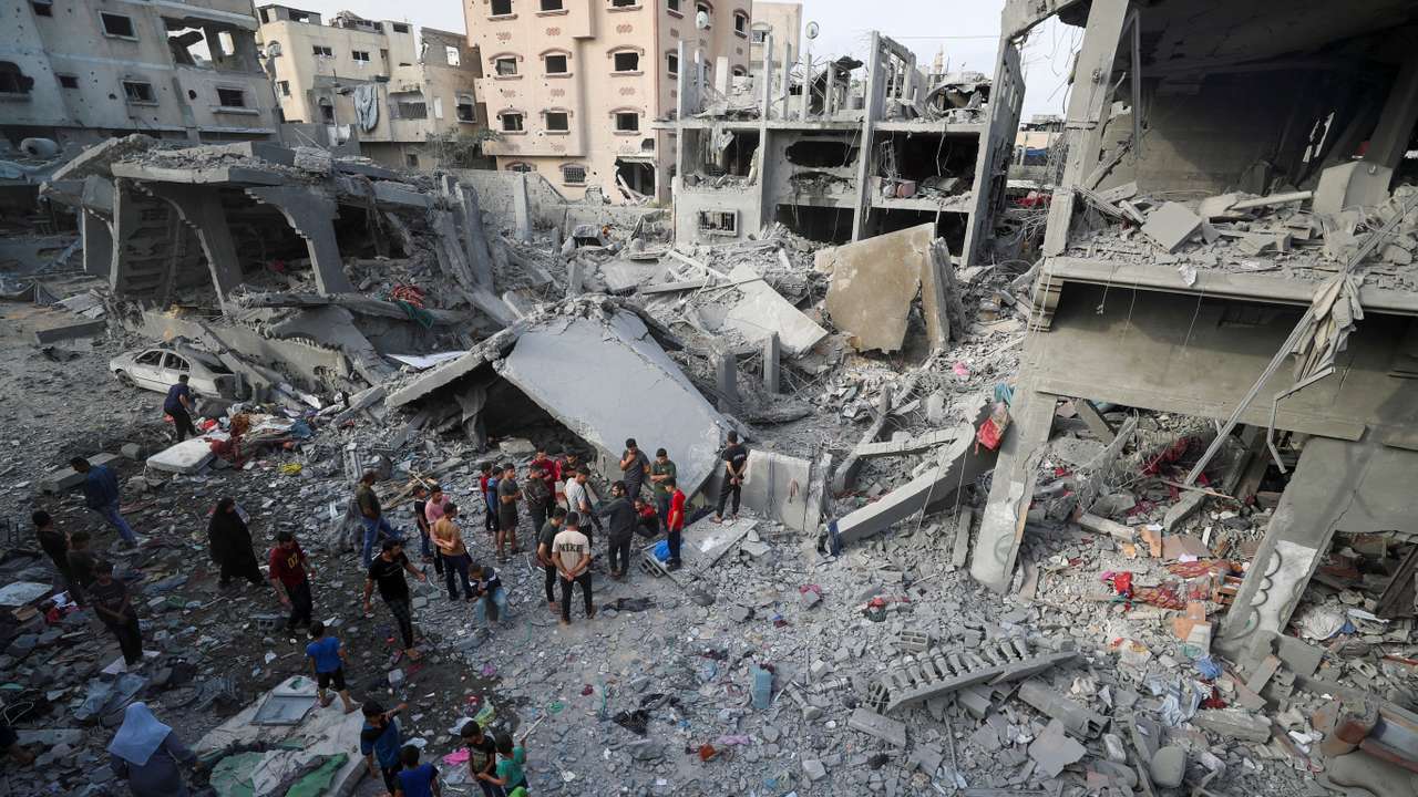Palestinians inspect the site of an Israeli strike on a house, in Jabalia, northern Gaza Strip