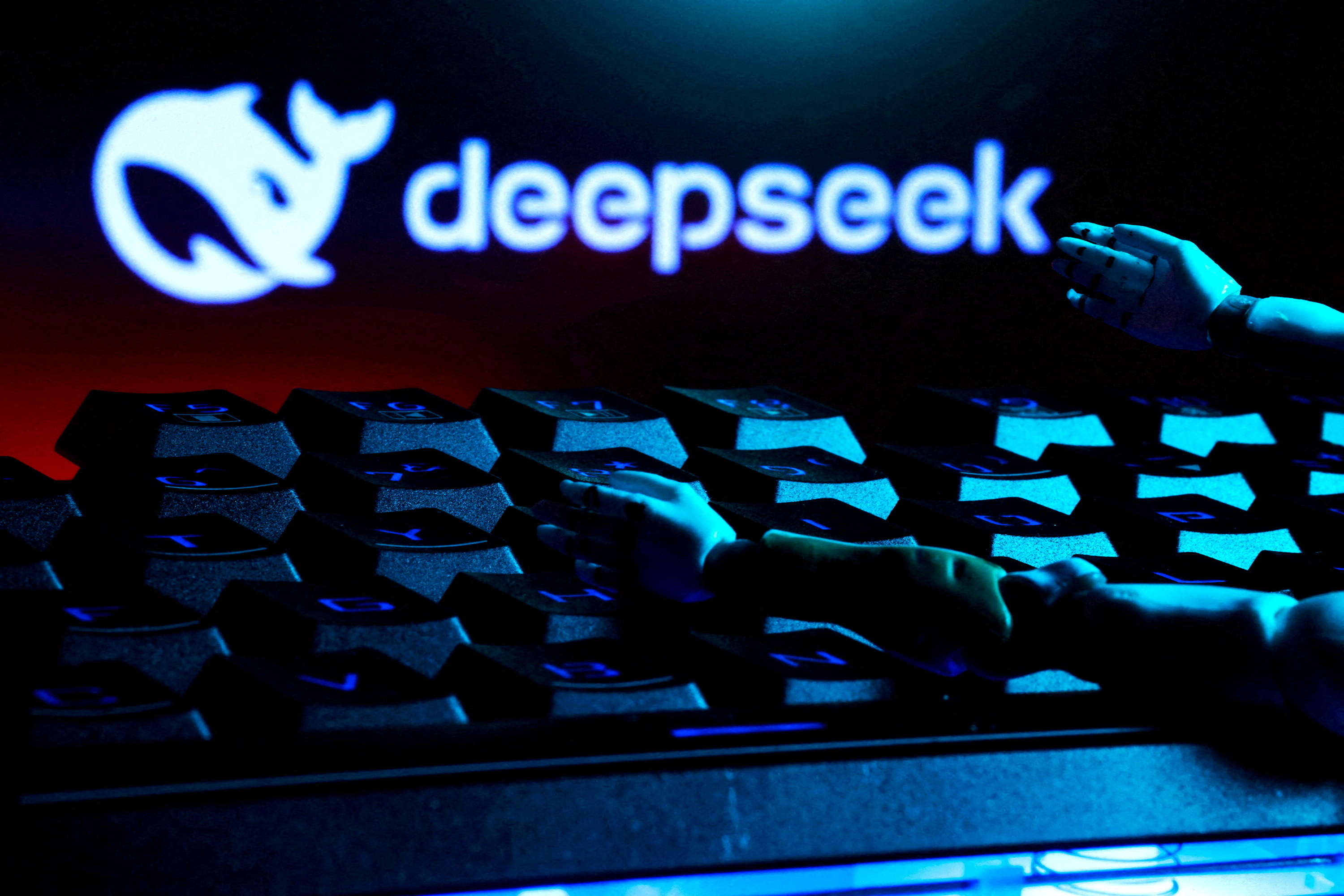 FILE PHOTO: FILE PHOTO: Illustration shows deepseek logo, keyboard, and robot hands