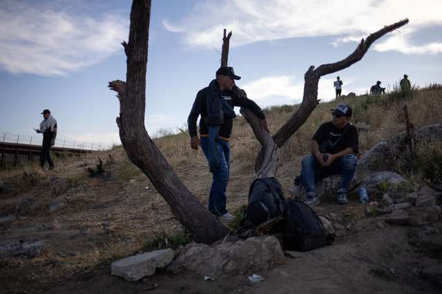 Migrants from Colombia await transport after crossing into U.S. from Mexico in Jacumba Hot Springs