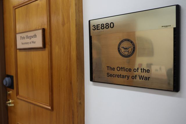 Signage is replaced after Trump ordered return to the US 'War Department', in Washington