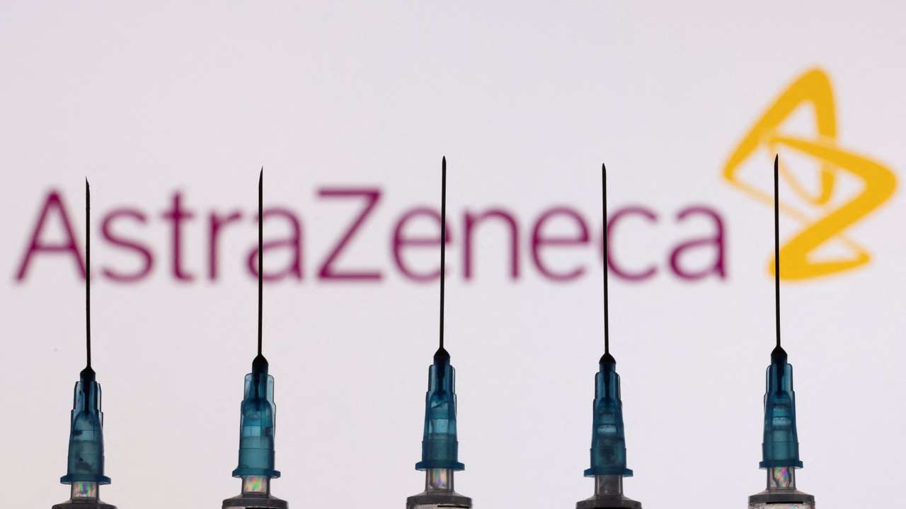 FILE PHOTO: Syringes with needles are seen in front of a displayed AstraZeneca logo in this illustration taken