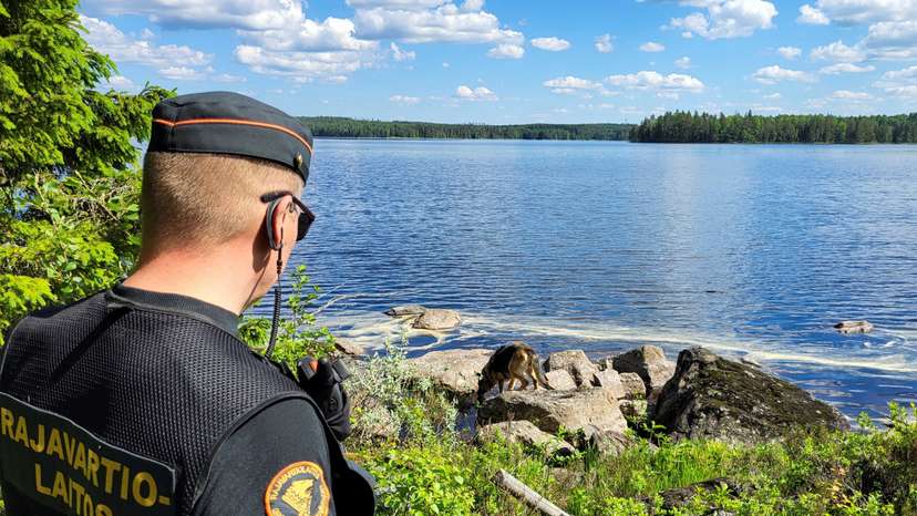 FILE PHOTO: A Finnish border guard and their dog Nita patrol the Finnish-Russian border near Hoilola