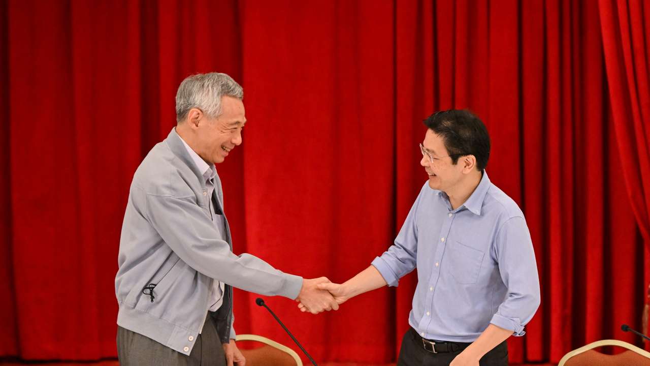 PM Lee shake hands with Finance Minister Lawrence Wong in Singapore