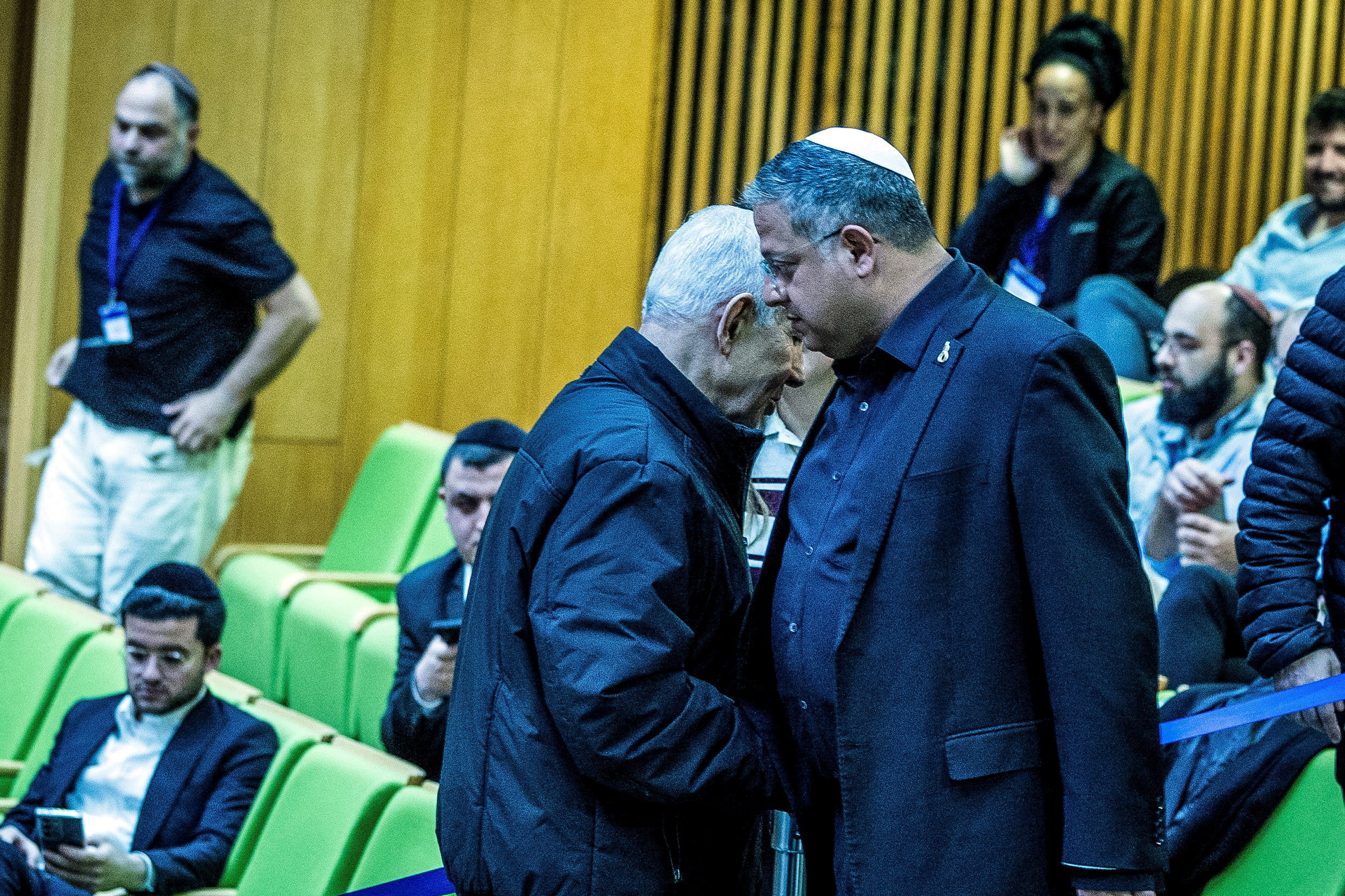 Israeli Prime Minister Benjamin Netanyahu and Israel's far-right National Security Minister Itamar Ben-Gvir shake hands as they attend a session at the Knesset, Israeli parliament, in Jerusalem