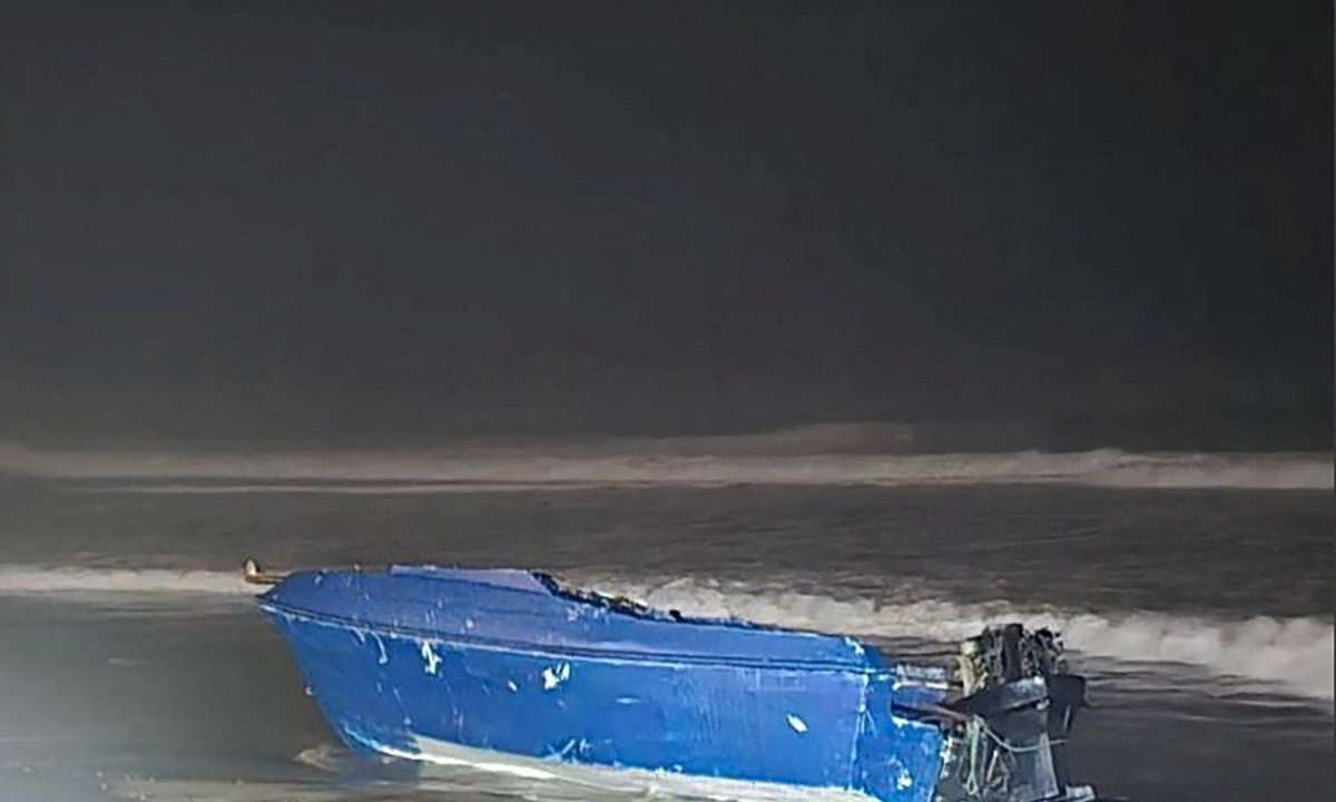 A vessel which capsized off the coast lies on a beach in Imperial Beach