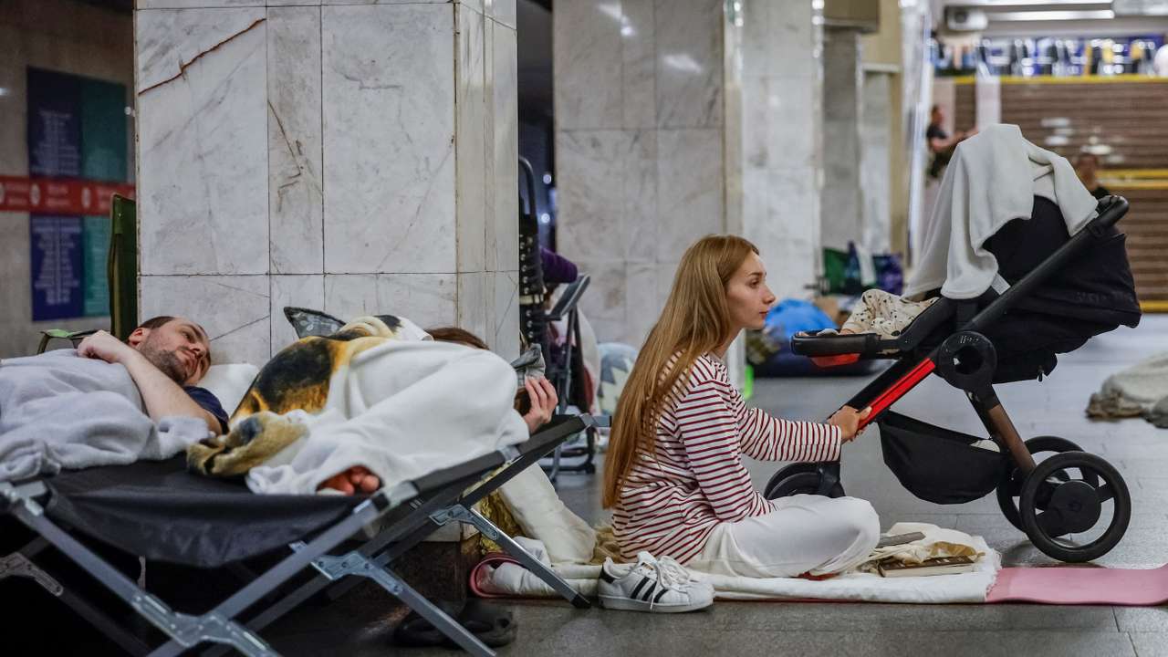 Daria Slavytska takes shelter inside a metro station with her son during a Russian missile and drone strike, in Kyiv