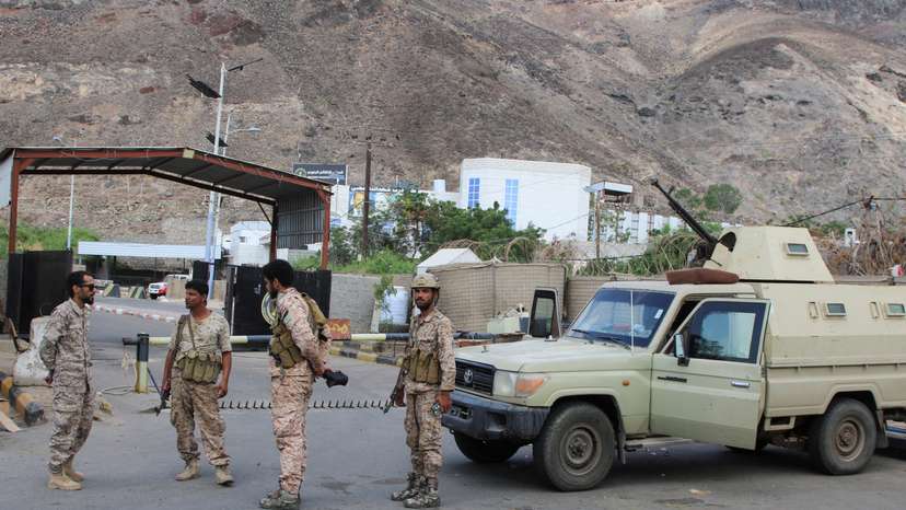 Soldiers gather outside the headquarters of the Southern Transitional Council in Aden