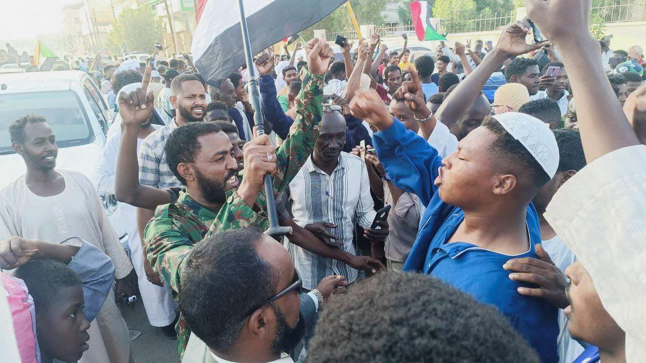 Sudanese citizens celebrate following an announcement by the army that it took over the city of Wad Madani, in Port Sudan