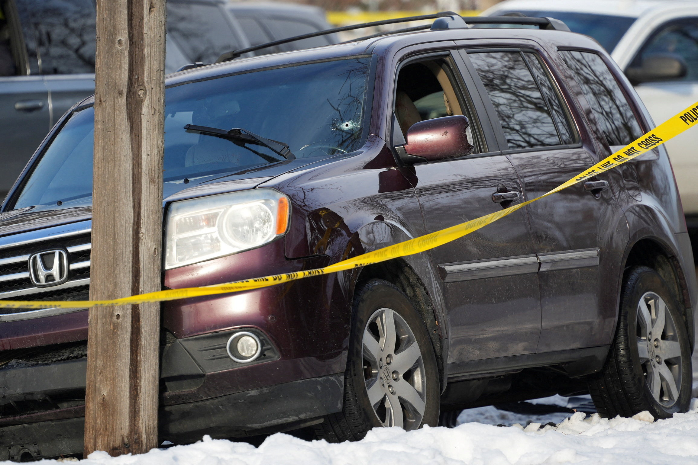 Members of U.S. Immigration and Customs Enforcement (ICE) stand guard after a driver of a vehicle was shot in Minneapolis