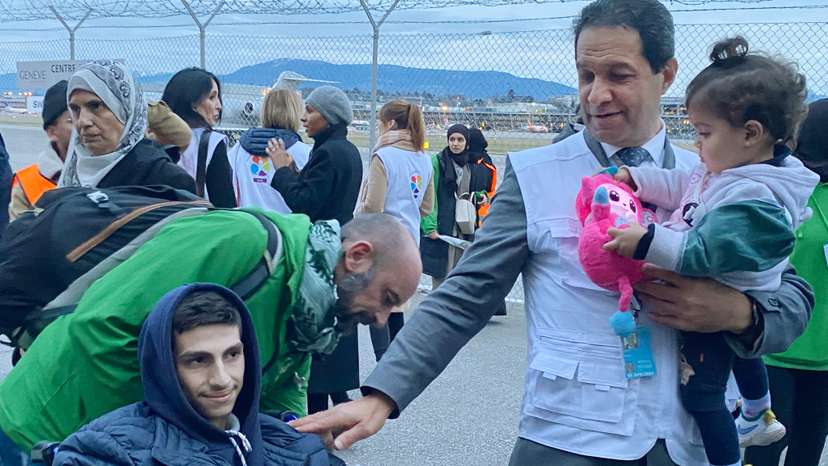 Geneva-based doctor Raouf Salti holds 17-month-old Zeina, next to 16-year-old Yussef, both of whom were evacuated from Gaza to Switzerland to receive medical treatment, at Geneva airport