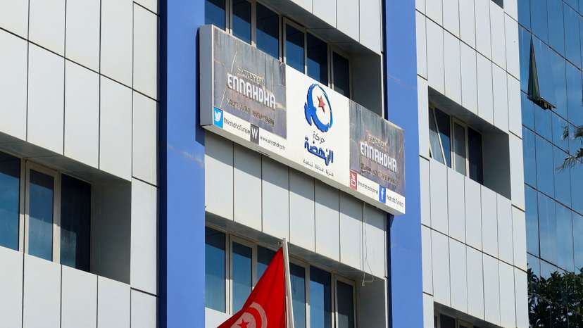 A Tunisian flag flutters outside the building of Ennahda party headquarters, in Tunis
