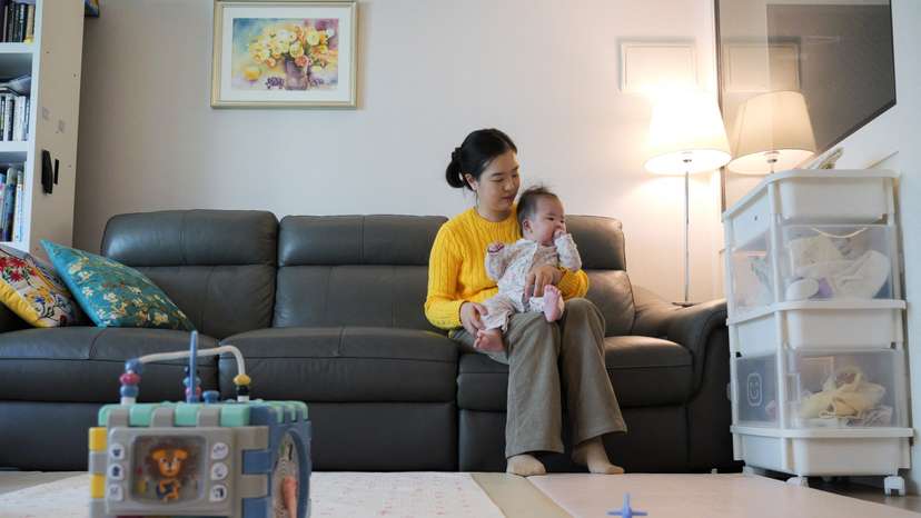Nam Hyun-jin takes care of her baby at her home in Seoul