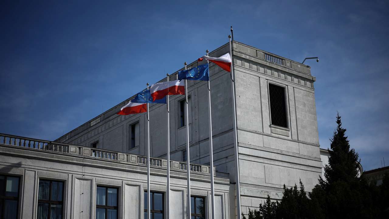 Polish and European Union flags are seen in front of the Polish Parliament building in Warsaw