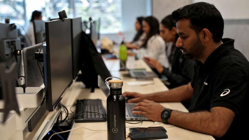 Employees work inside the office of Moss Adams, a U.S. accounting firm, in Bengaluru