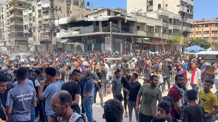 Palestinians wait to receive aid, in Gaza