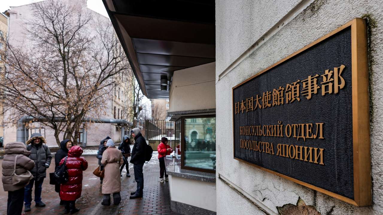 People queue outside the Japanese embassy in Moscow