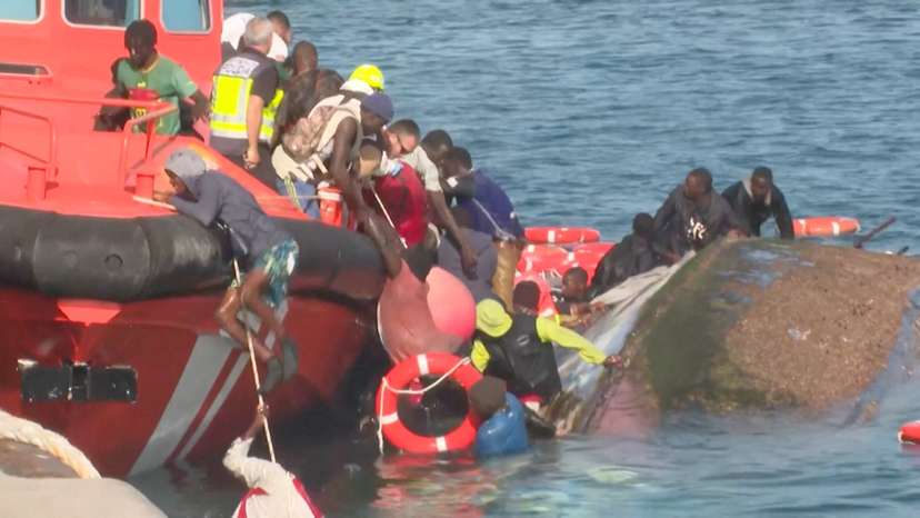 A view shows emergency services trying to rescue migrants from the water, as a migrant boat capsized, in La Restinga