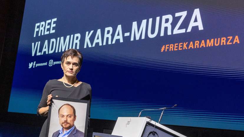 Evgenia wife of jailed Russian opposition figure Kara-Murza poses with a picture of her husband in Geneva
