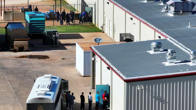 Detainees are escorted off of a bus at the Bluebonnet Detention Facility, in Anson