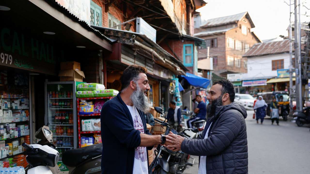 Kashmiri men greet each other after the ceasefire announcement between India and Pakistan, in Srinagar
