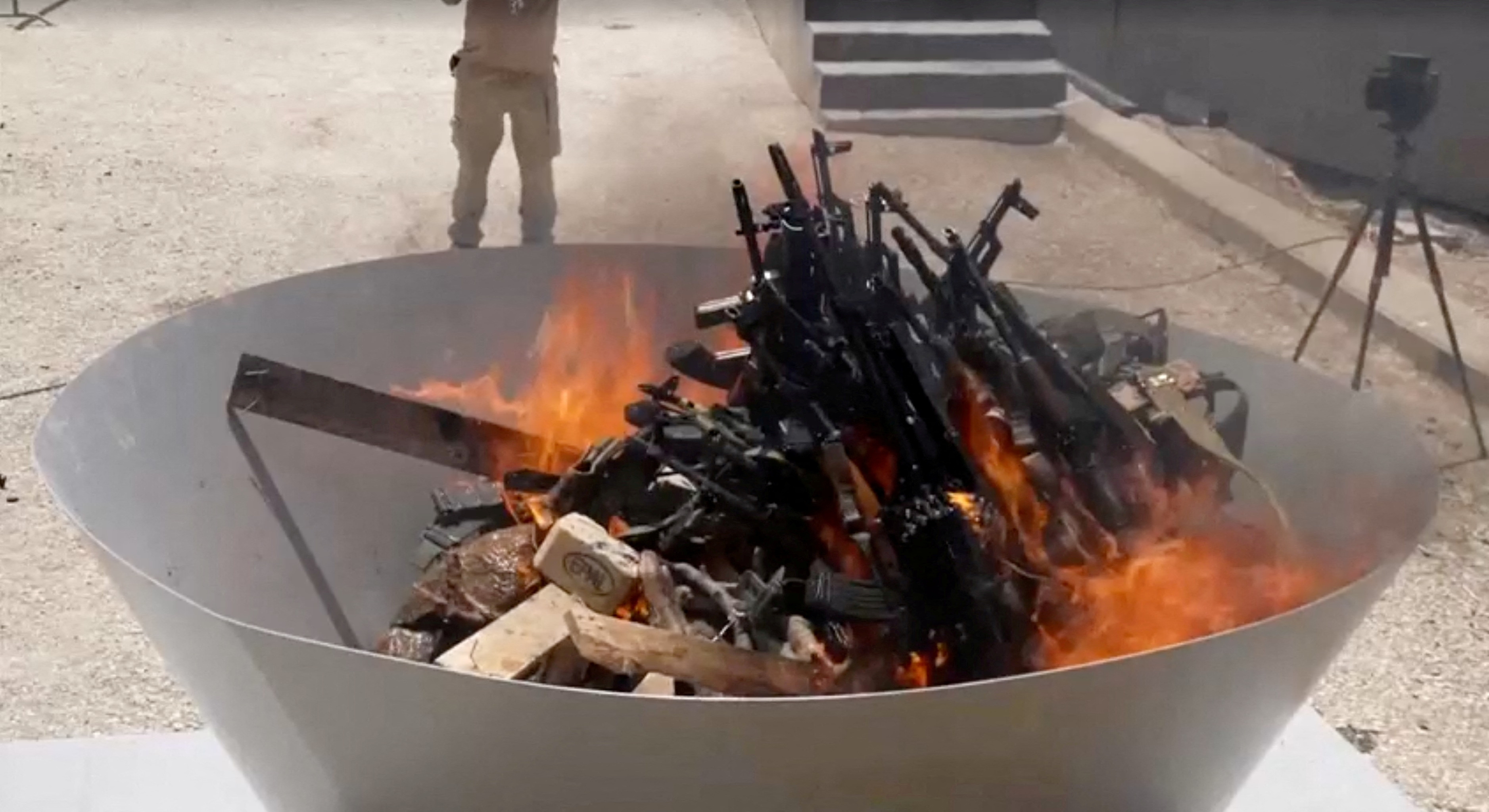 PKK fighters burn weapons during disarming ceremony in Iraqi Kurdistan