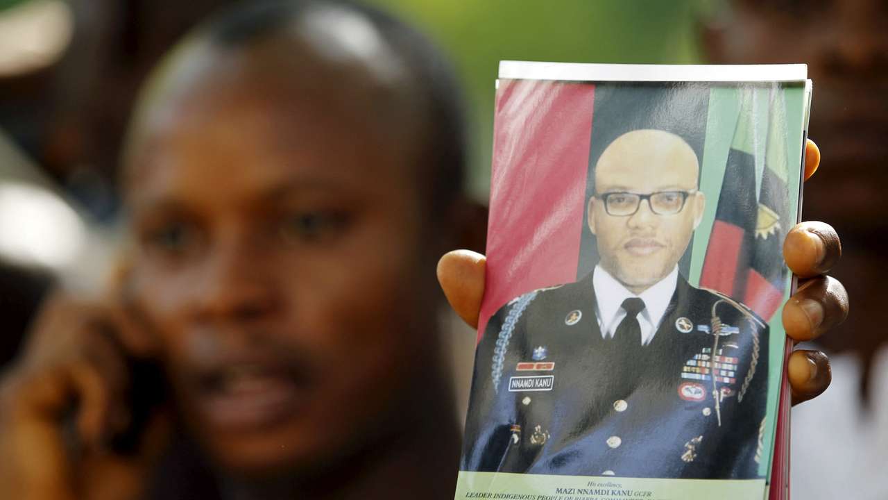 FILE PHOTO: A supporter of Indigenous People of Biafra (IPOB) leader Nnamdi Kanu holds a photograph of Kanu, who is expected to appear at a magistrate court, during a rally in Abuja
