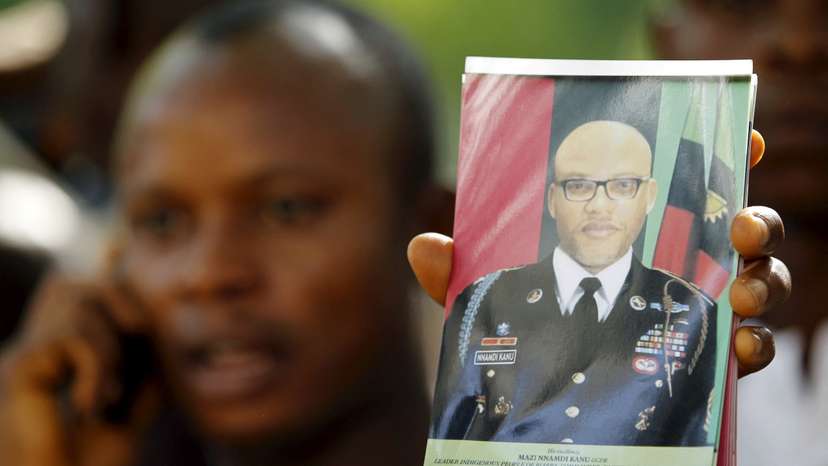 FILE PHOTO: A supporter of Indigenous People of Biafra (IPOB) leader Nnamdi Kanu holds a photograph of Kanu, who is expected to appear at a magistrate court, during a rally in Abuja