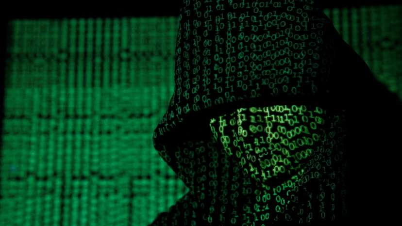 FILE PHOTO: Projection of cyber code on hooded man is pictured in this illustration picture