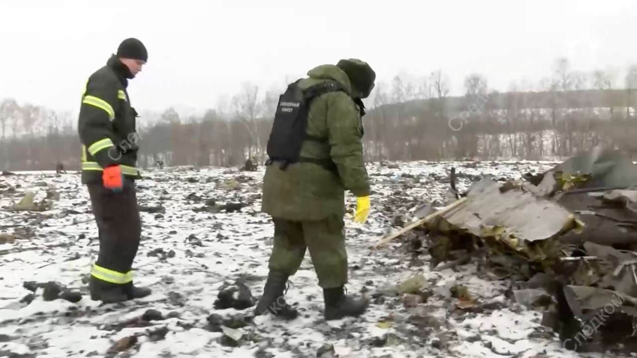 Investigators work at the crash site of Russian Il-76 military plane in Belgorod region