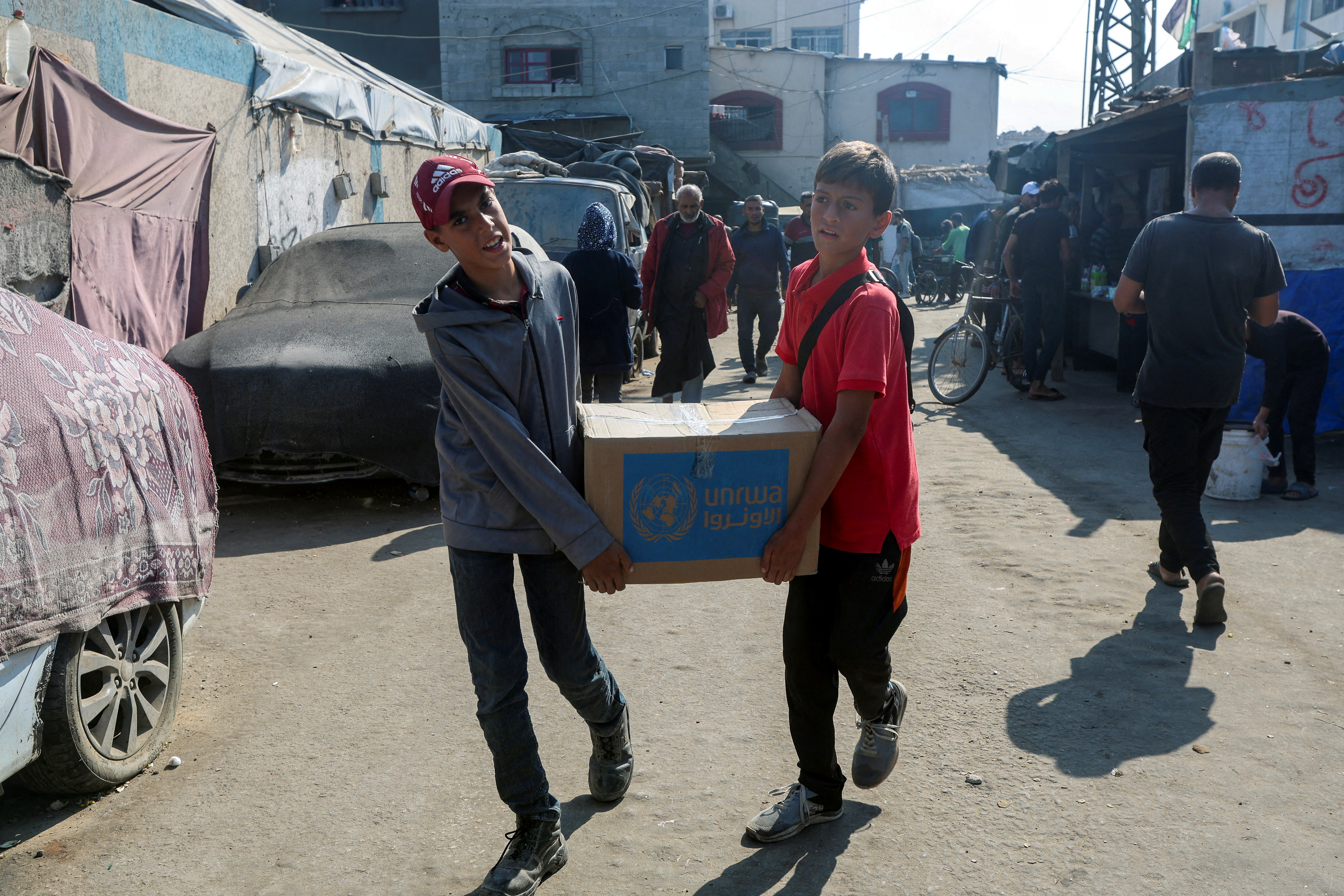 Palestinians receive aid from UNRWA in Deir Al-Balah, central Gaza Strip