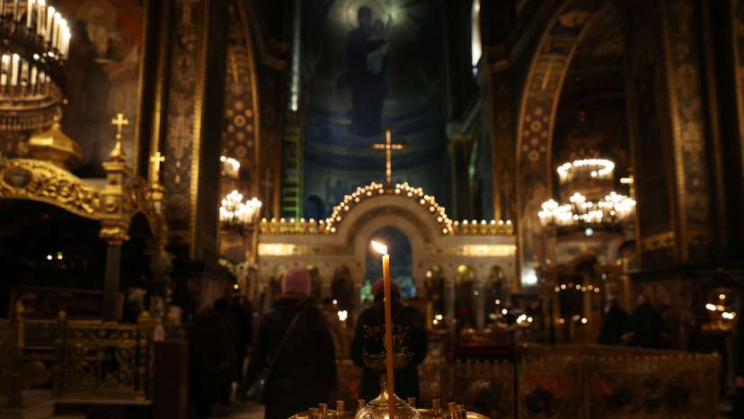 People attend early morning Ukrainian Orthodox Church services at St Volodymyr's Cathedral in Kyiv