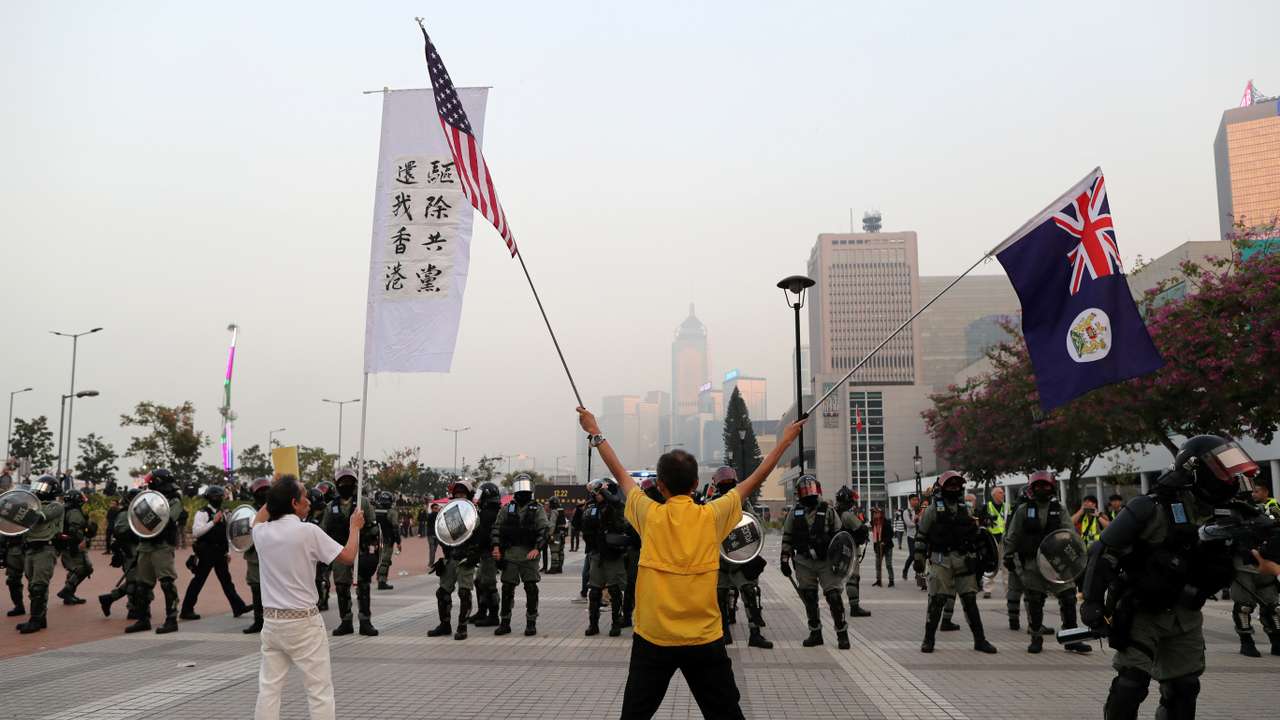 FILE PHOTO: Hong Kong protesters face off against riot police at a rally in support of the human rights of Xinjiang Uighurs in Hong Kong