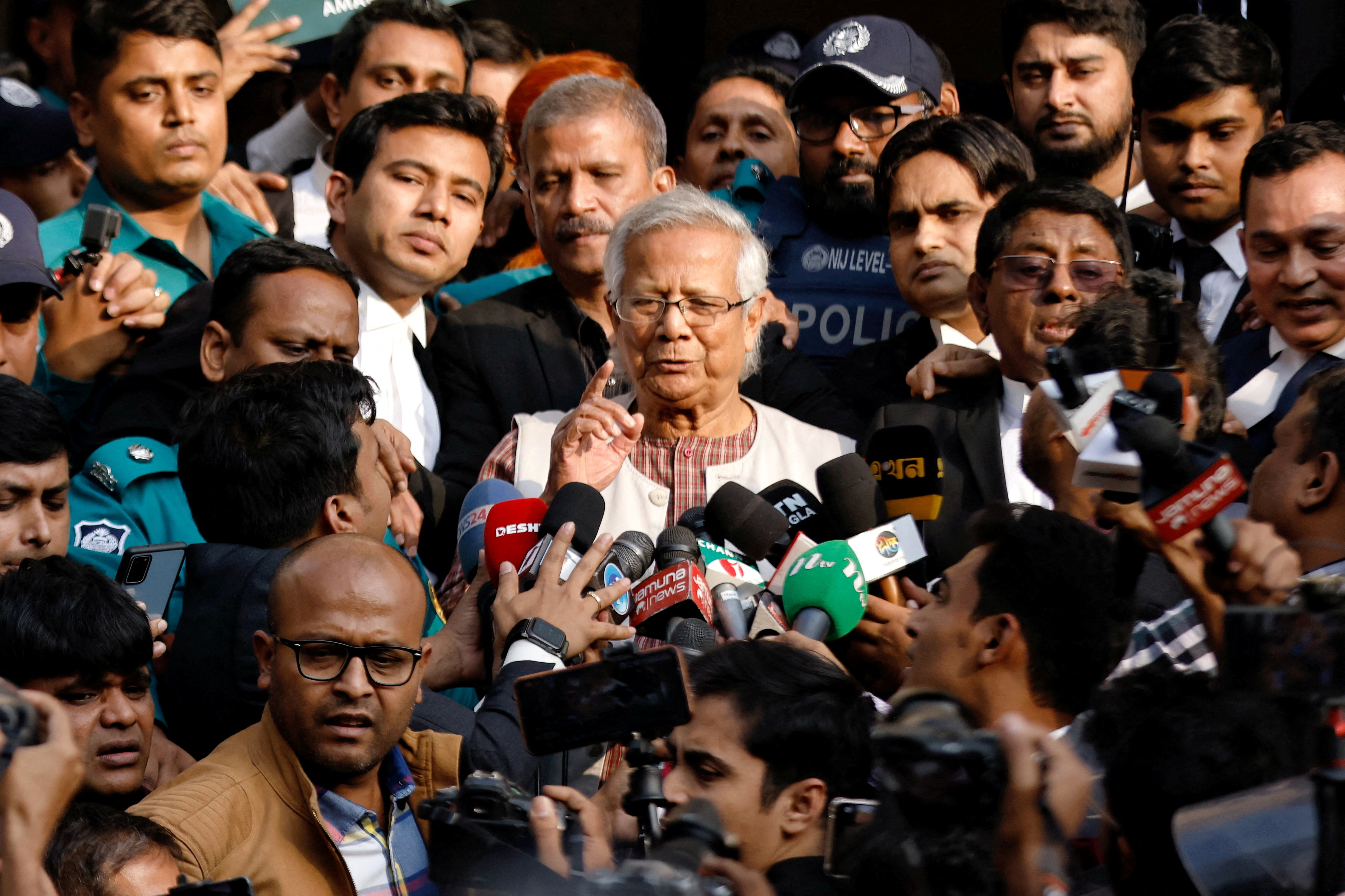 FILE PHOTO: Bangladeshi Nobel peace laureate Professor Muhammad Yunus gestures in front of the court after being sentenced for six months of imprisonment, in Dhaka