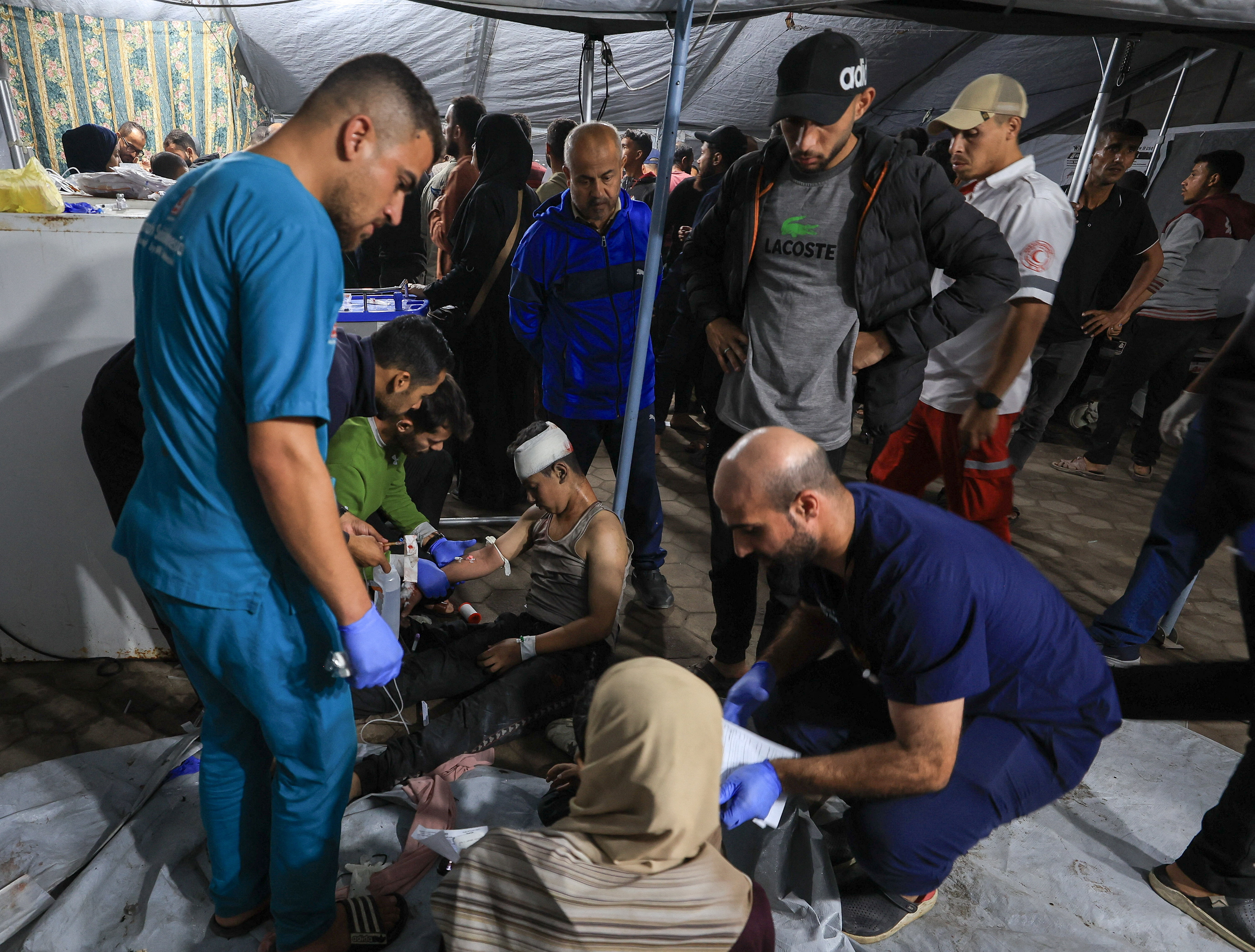 An injured Palestinian receives treatment following an Israeli air strike, according to medics, at Al-Ahli Arab Hospital in Gaza City