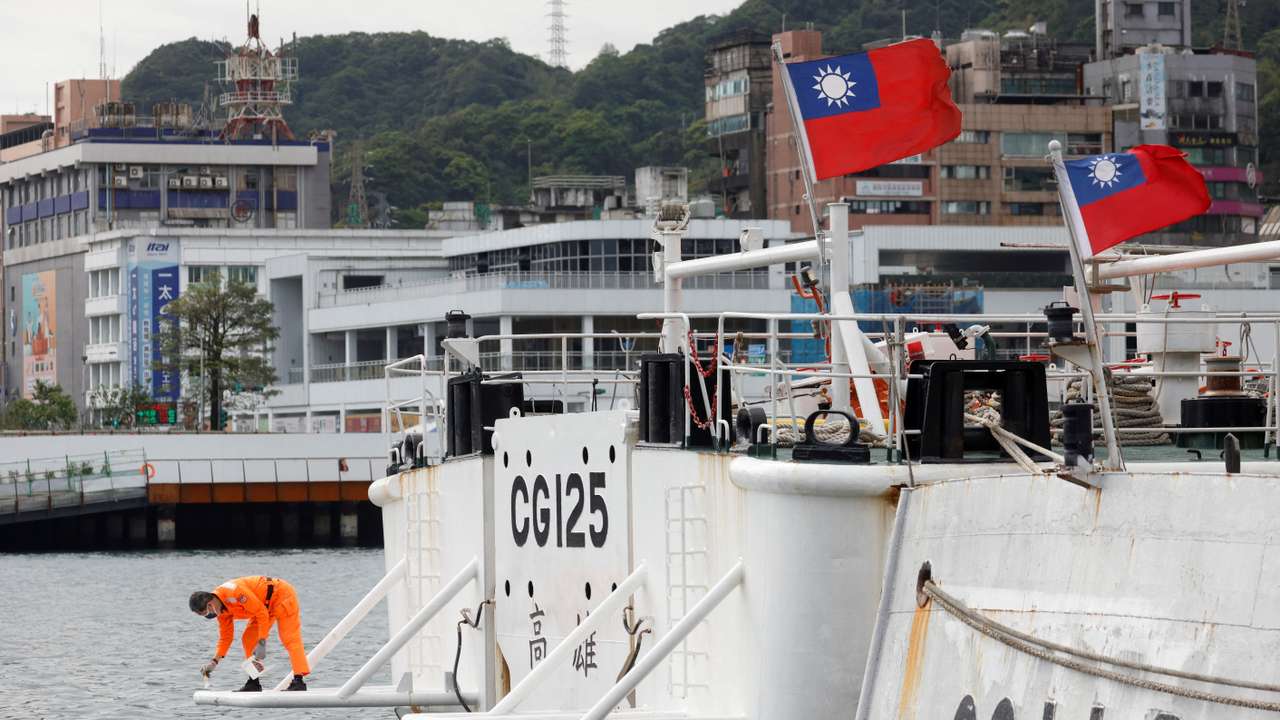 FILE PHOTO: A crew member works aboard a Taiwanese Coast Guard vessel ducked at the port in Keelung