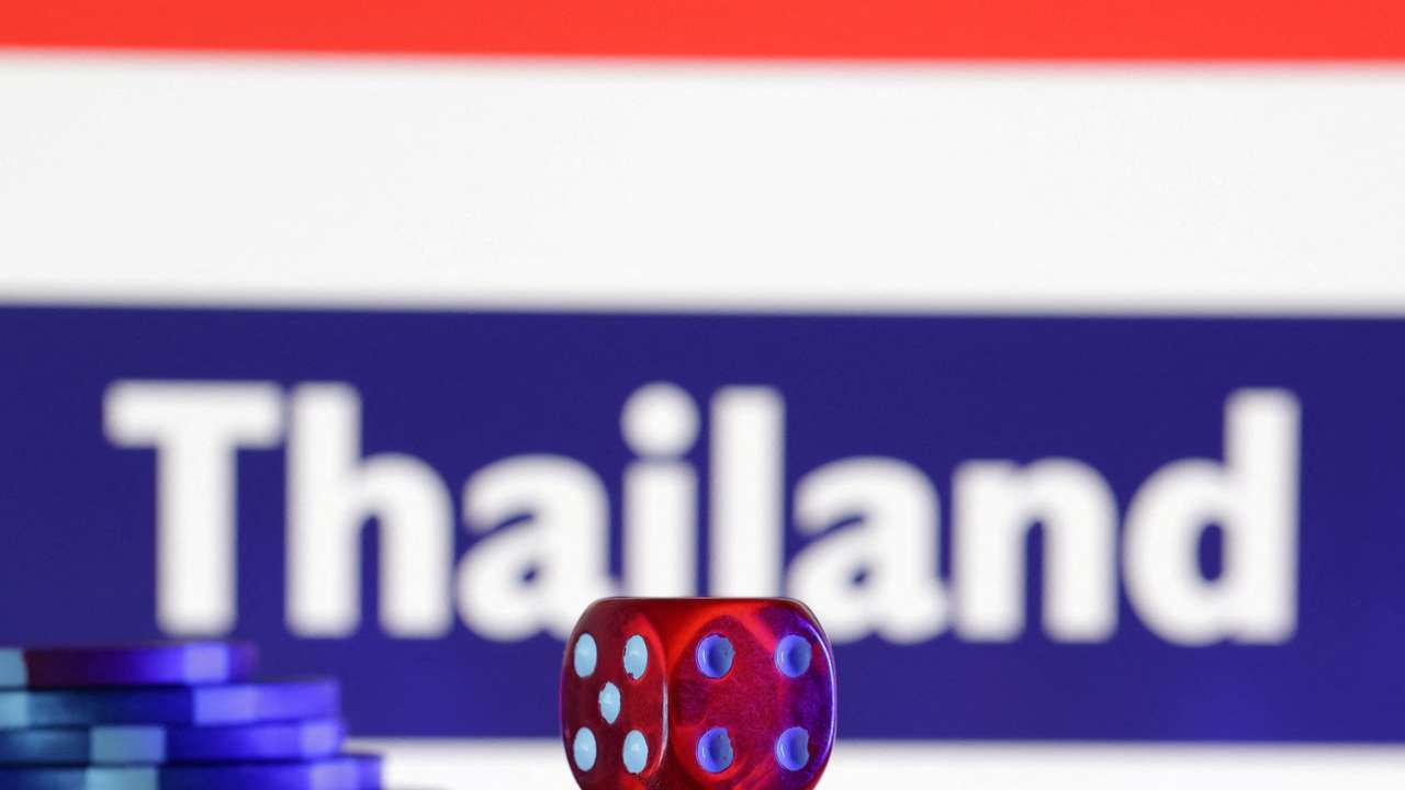 FILE PHOTO: Gambling cubes and chips are seen in front of a displayed Thailand flag and the word "Thailand" on it in this illustration taken February 11, 2025. REUTERS/Dado Ruvic/Illustration/File Photo
