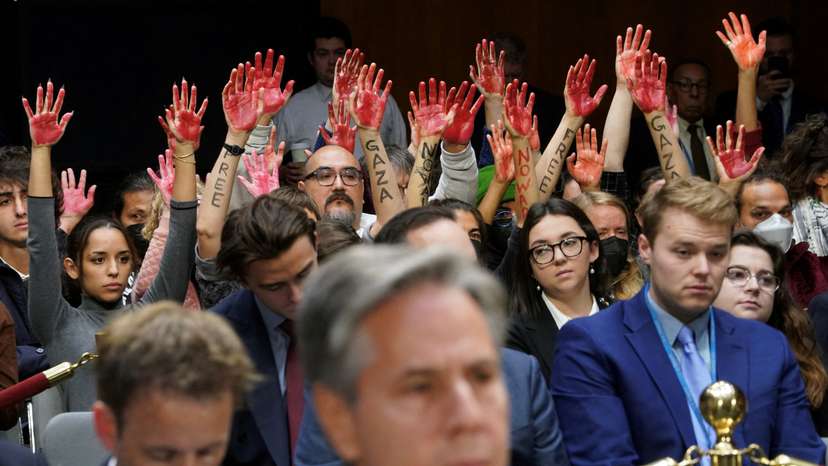 Anti-war protesters raise "bloody" hands behind Blinken at hearing on Capitol Hill in Washington