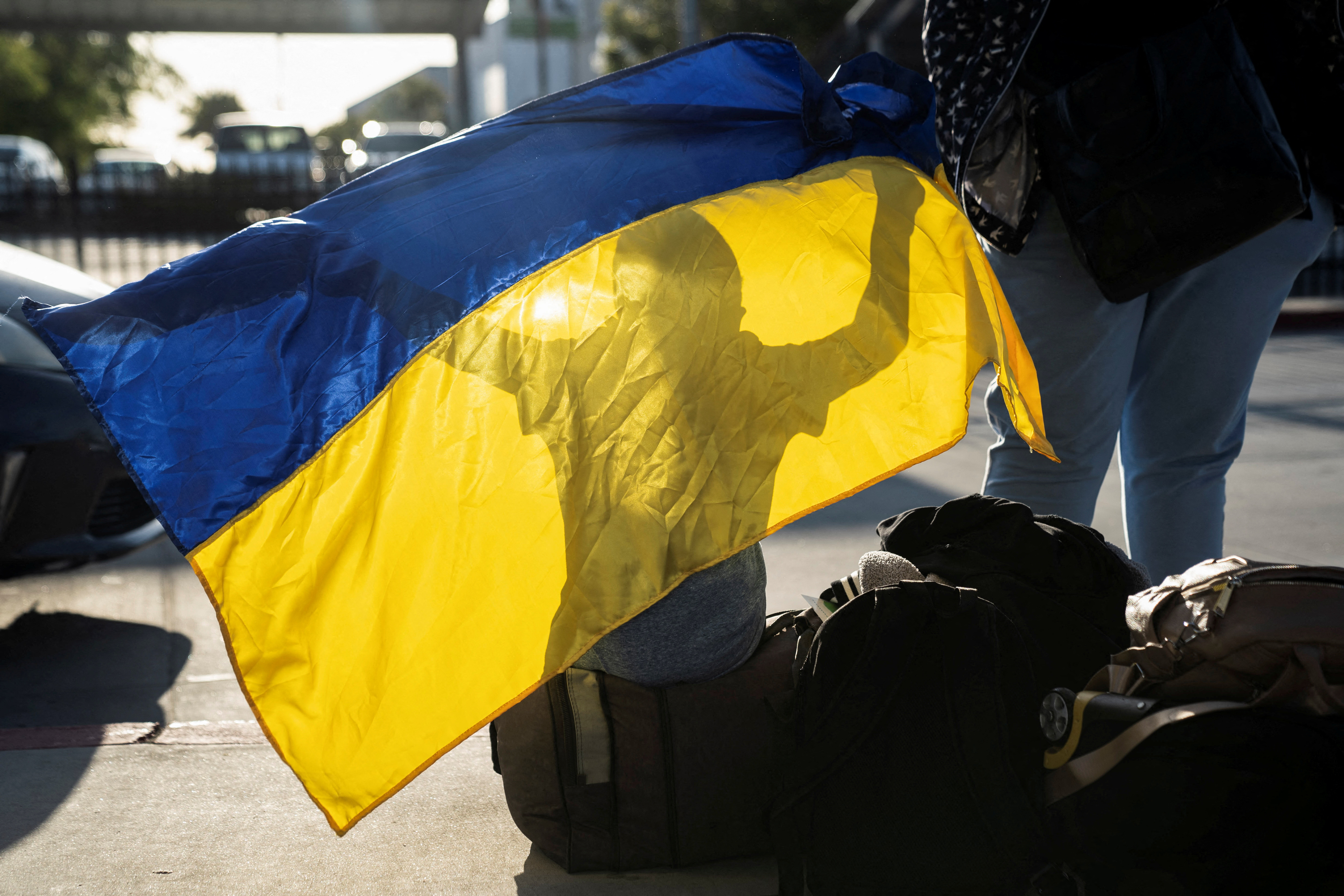 Ukrainians cross the U.S. border from Tijuana, in San Diego