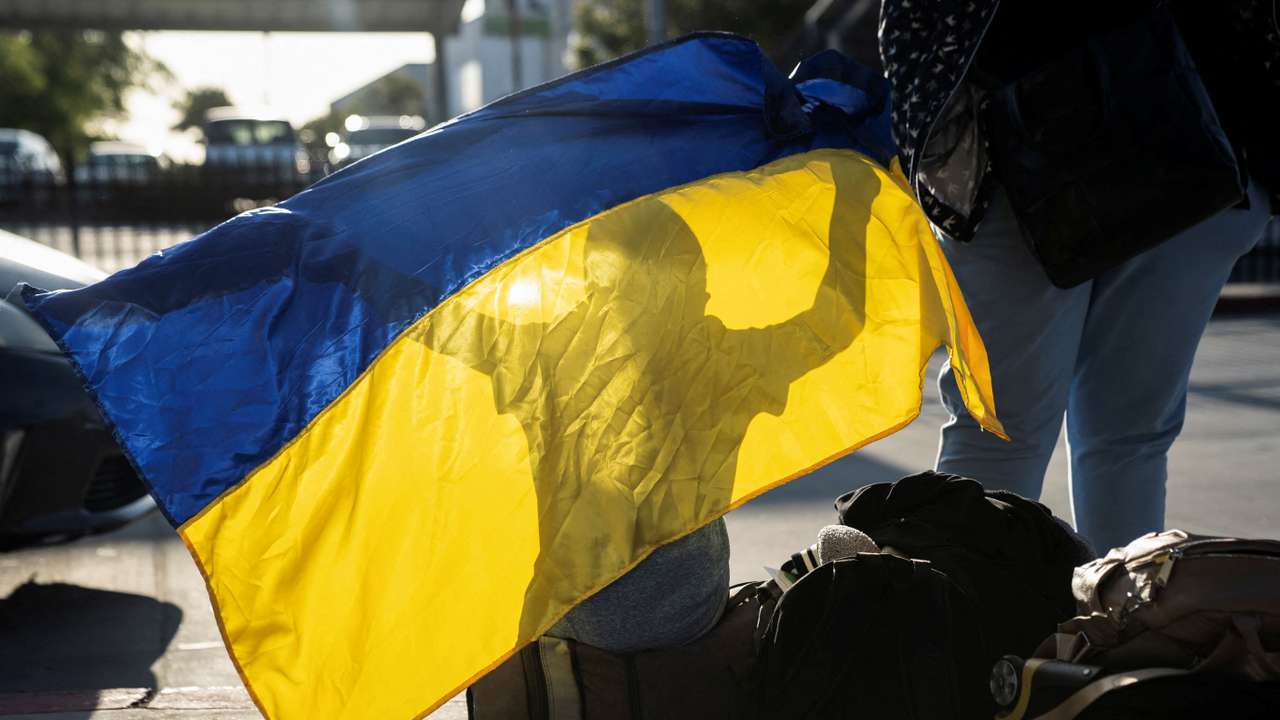 Ukrainians cross the U.S. border from Tijuana, in San Diego