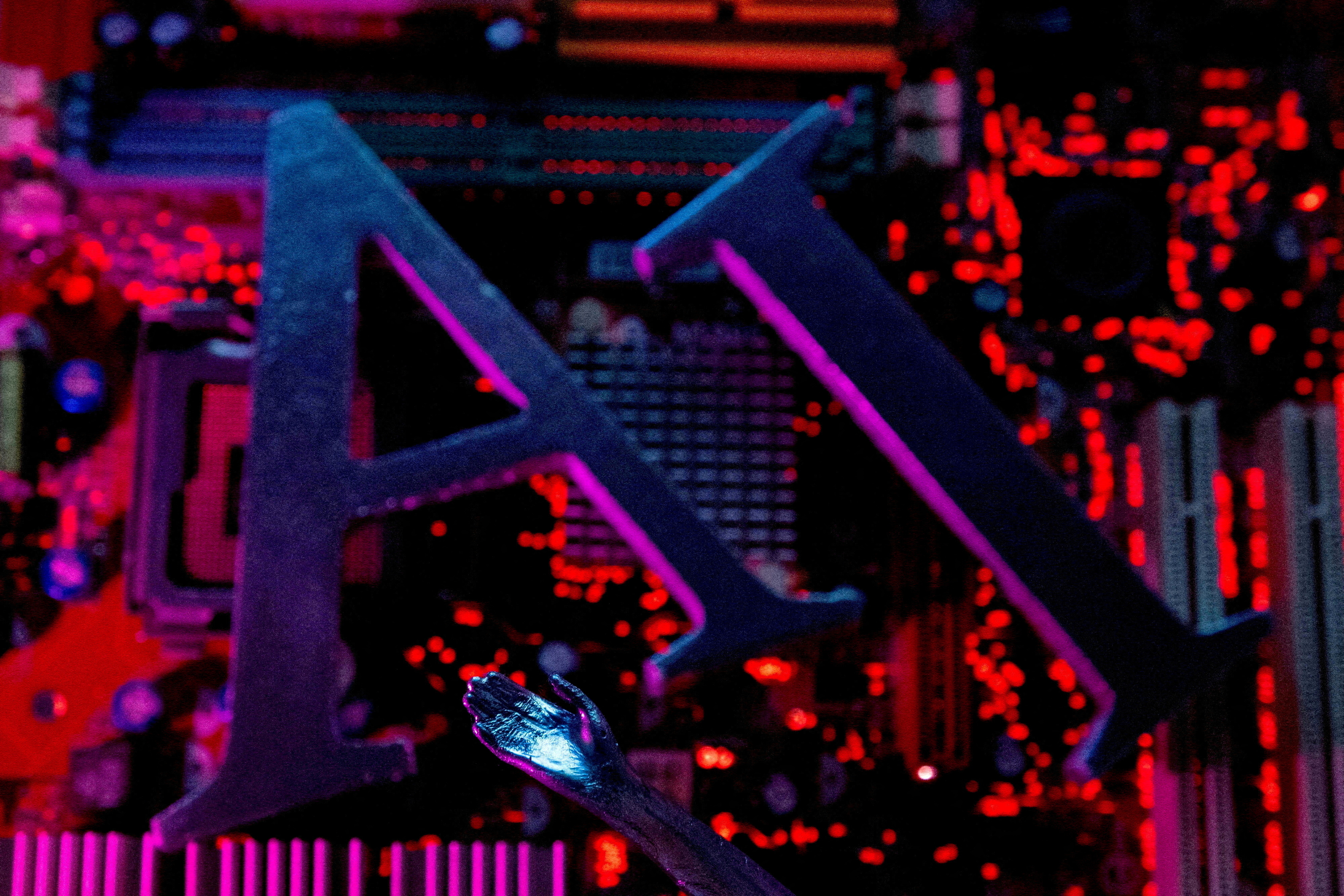 FILE PHOTO: Illustration shows AI (Artificial Intelligence) letters and robot hand