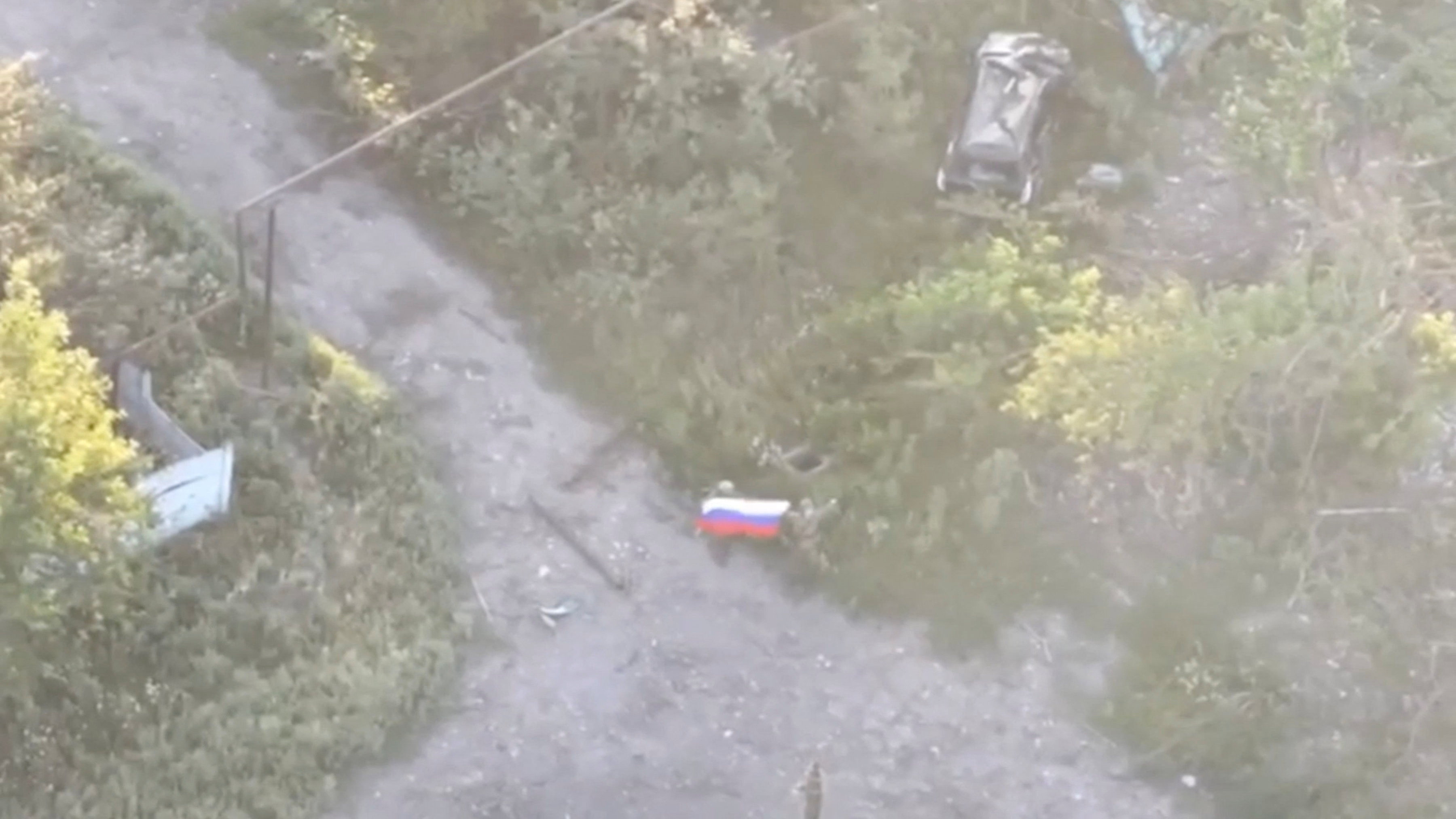 A still image from video released by Russian Defence Ministry shows what it said to be Russian soldier raising flag in Yablunivka in Donetsk region