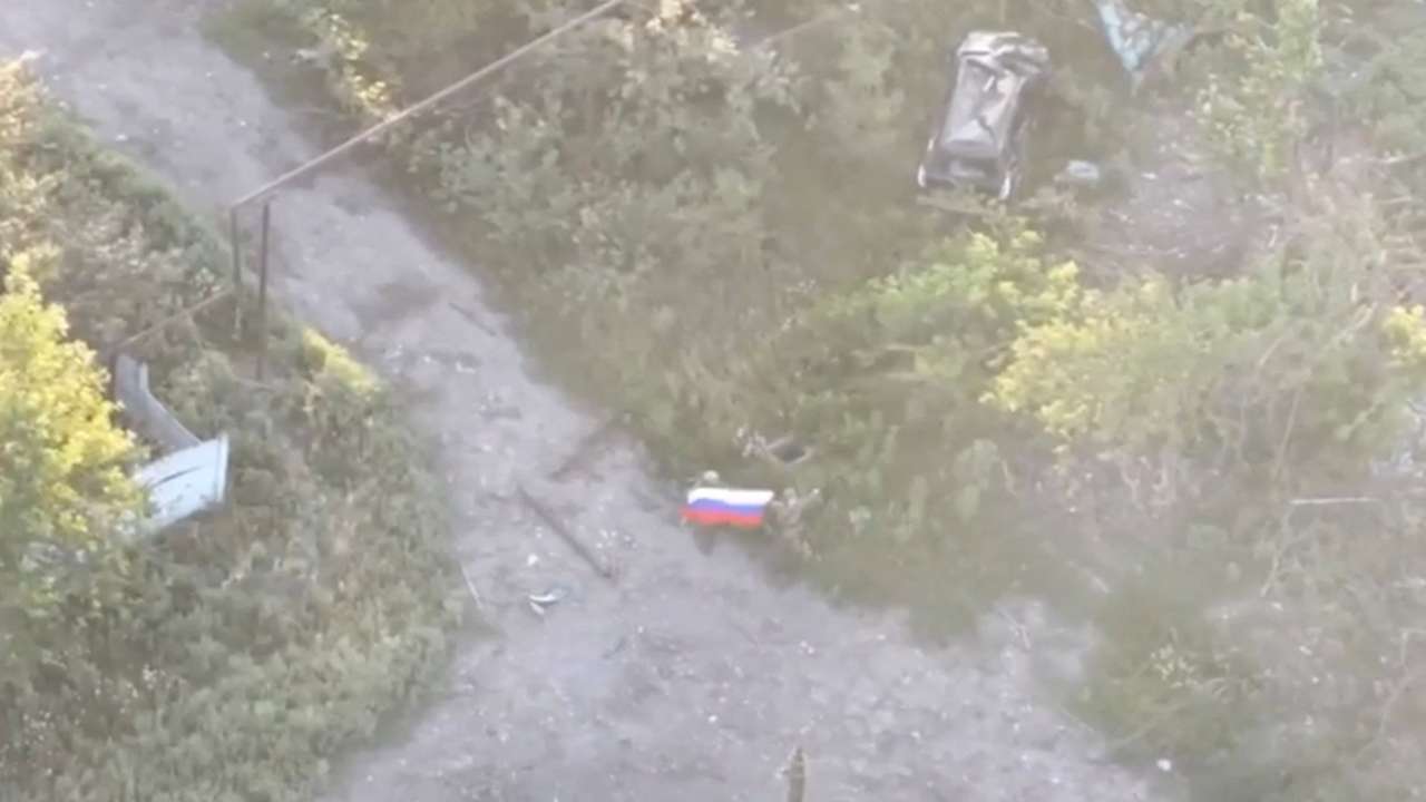A still image from video released by Russian Defence Ministry shows what it said to be Russian soldier raising flag in Yablunivka in Donetsk region