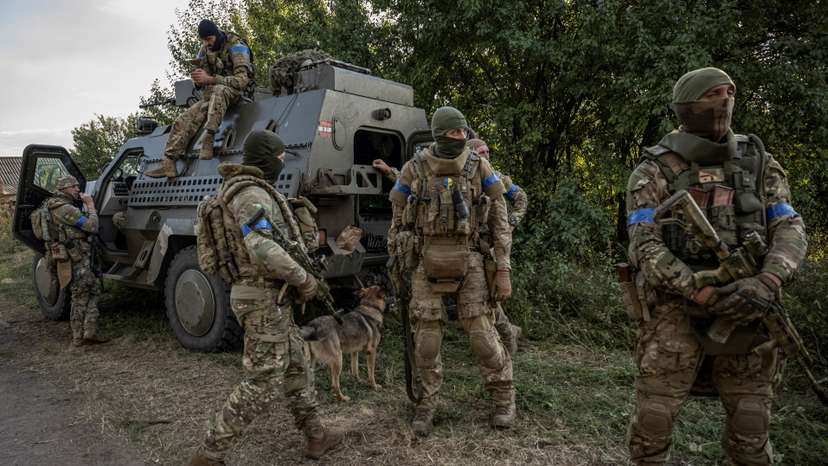 Ukrainian servicemen stand near a military vehicle, near the Russian border in Sumy region